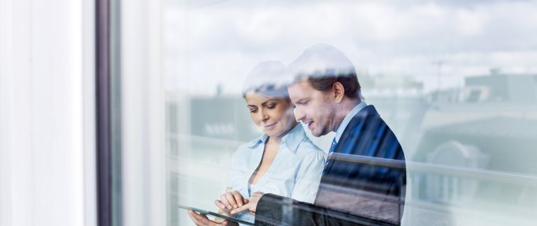man and woman looking at tablet foto istock