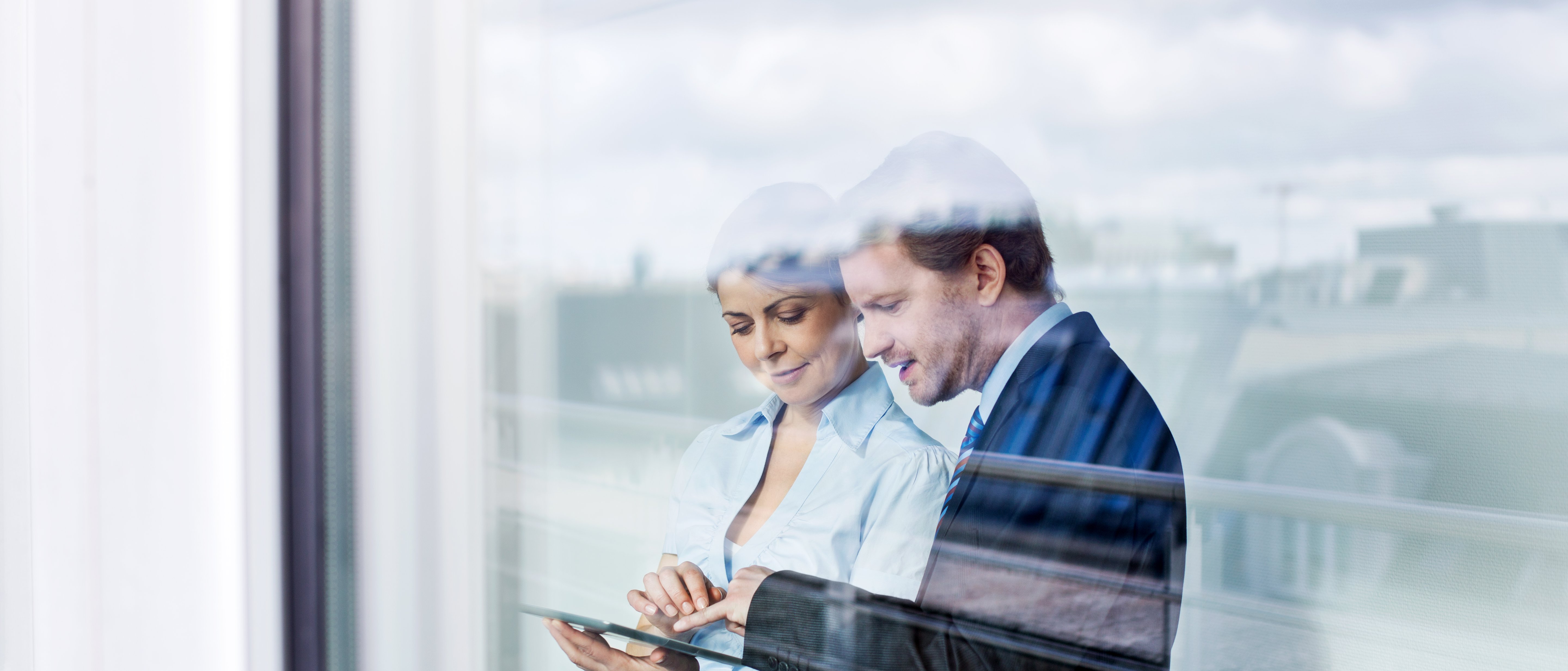 man and woman looking at tablet foto istock