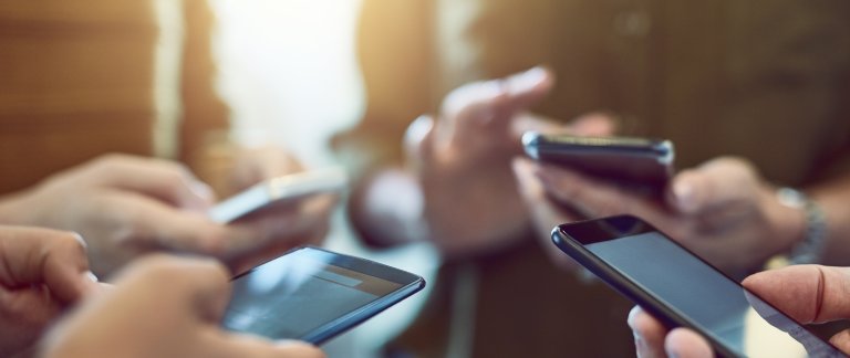 flere hender med telefoner foto istock