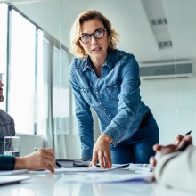 Businesswoman standing and leading business presentation. Female executive putting her ideas during presentation in conference room.